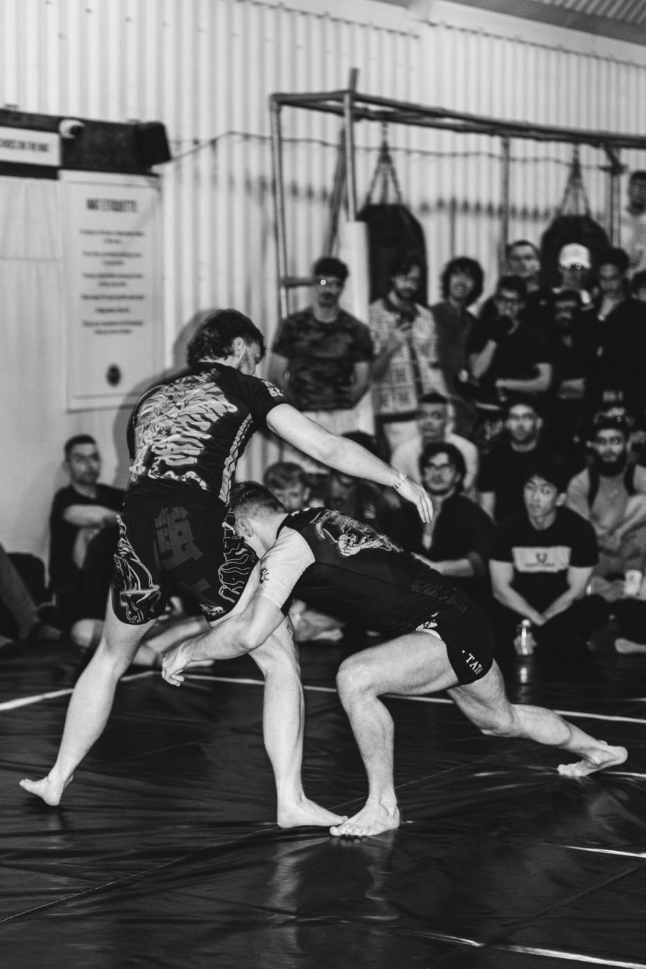 Grapplers sparring in a training gym