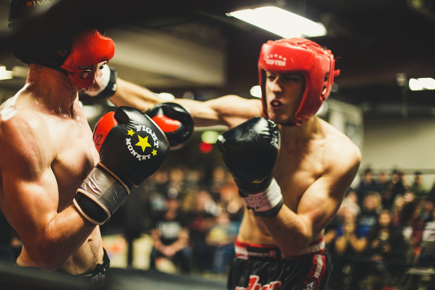 Two amateur boxers in headgear trading punches