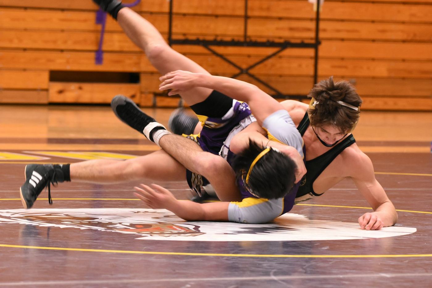 A young wrestler on the mat at practice