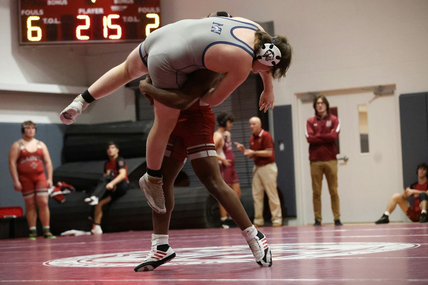 A wrestler lifting an opponent during a tournament match